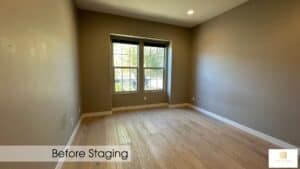 Empty room with large window, neutral walls, and hardwood flooring, ready for staging and transforma.